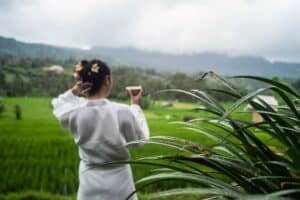 Woman enjoying a coup of tea overlooking the rice fields - Villa Uma Dewi Sri - Bali - Sidemen